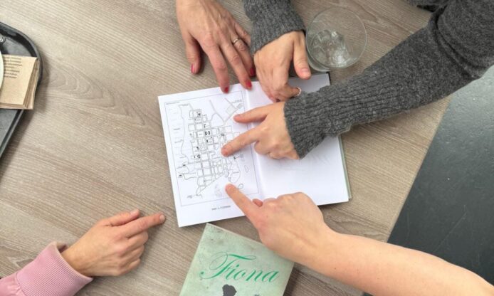 Ihmisten käsiä ja kirjoja.